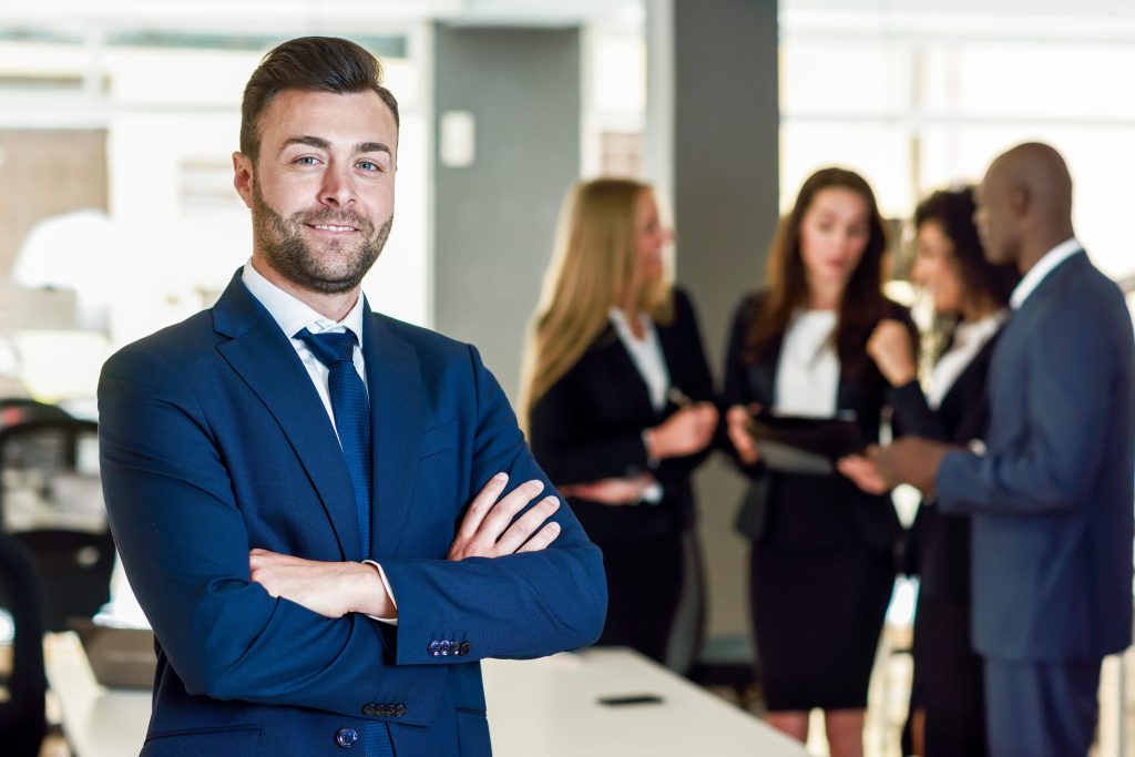 A tech founder implementing an executive thought leadership strategy by engaging with his team in a modern office setting.